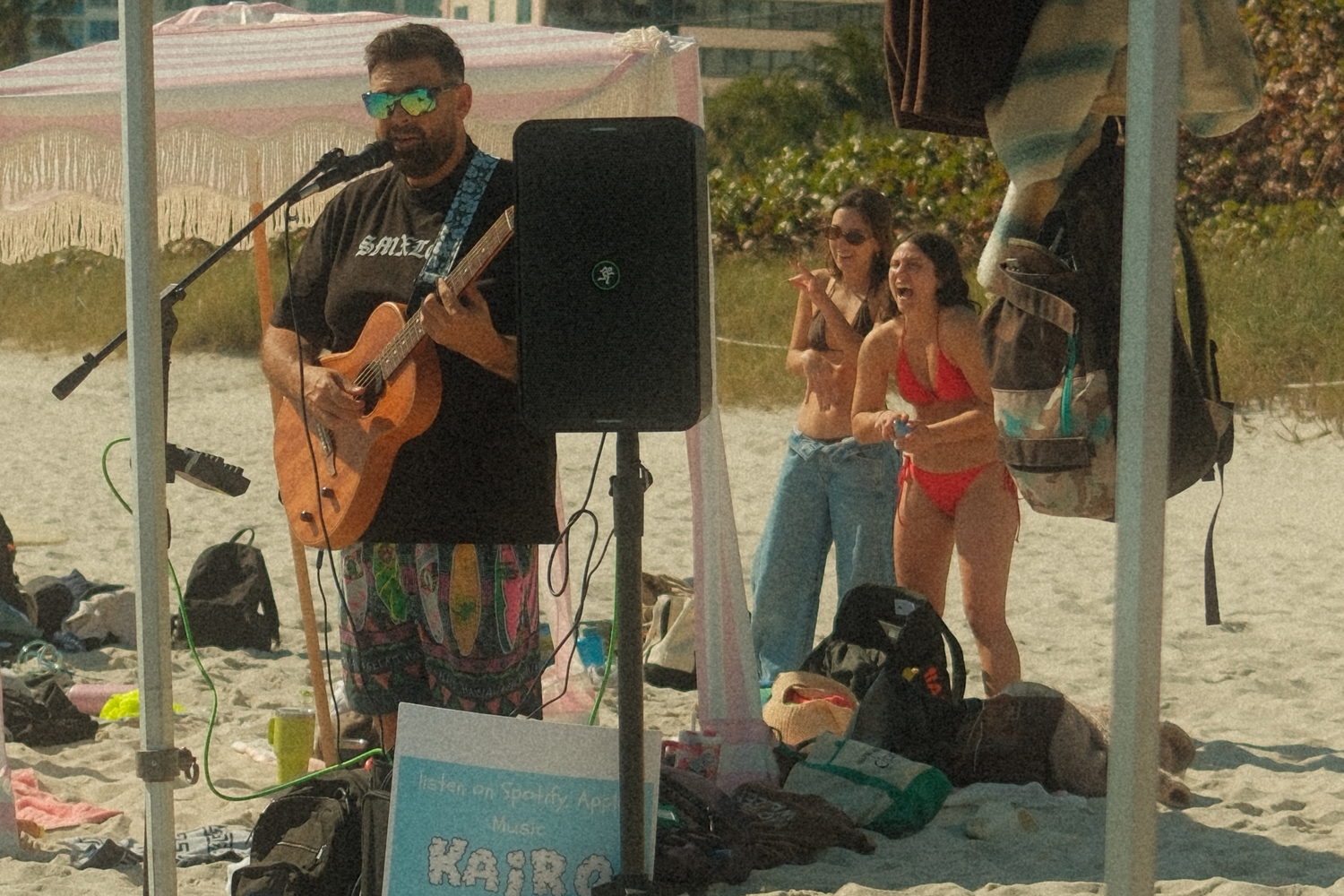 Kairo Reef playing a beach set as onlookers sing along